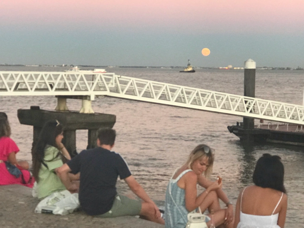 Lisbon waterfront sunset with a full moon rising