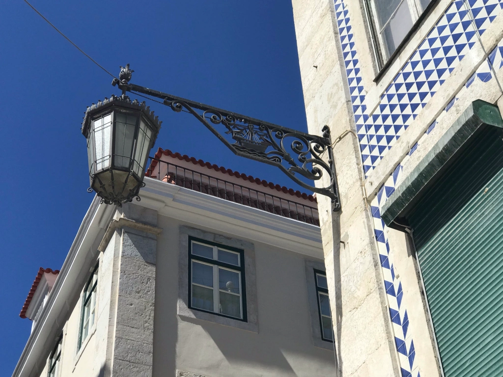 Lisbon streetlight decorated with a ship