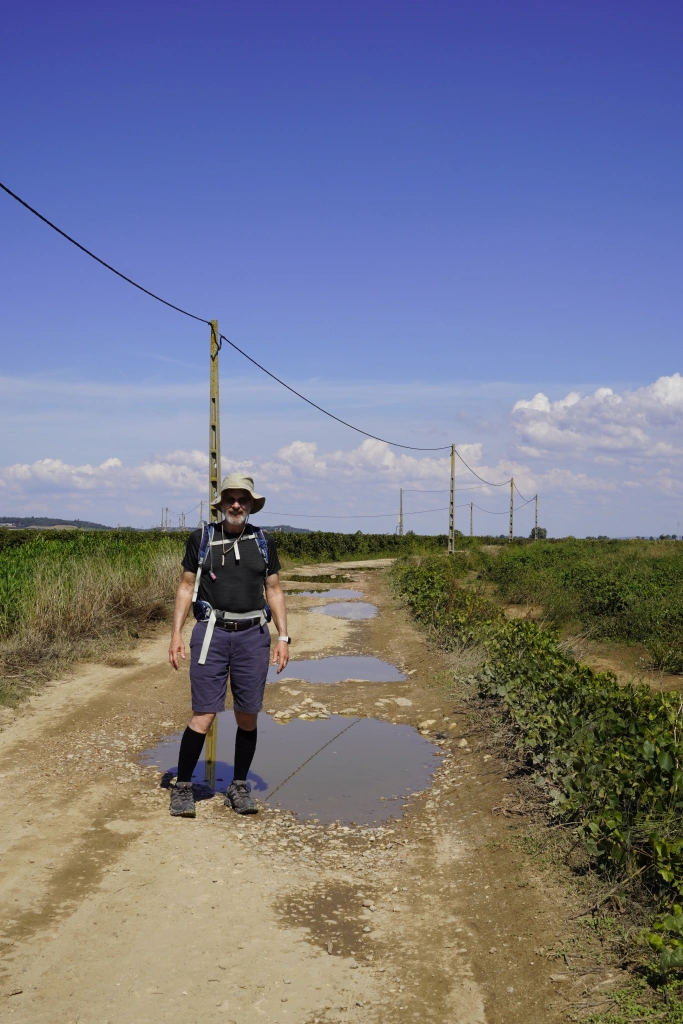 Richard on a puddle-filled road