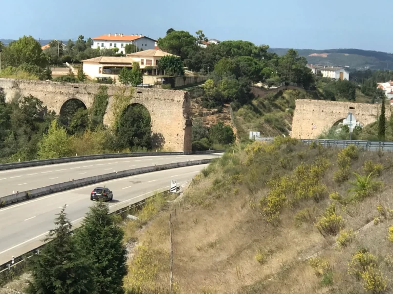 Coimbra highway bisects an ancient arched wall