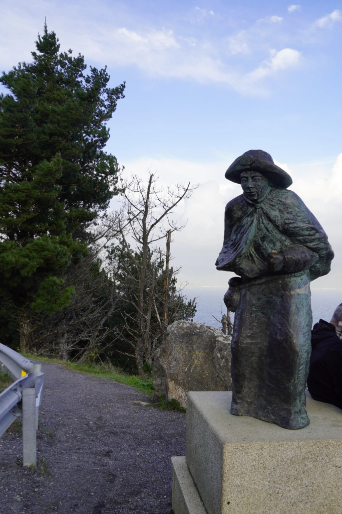 A statue of a pilgrim walking to the Faro